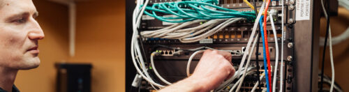 Male managed IT service provider works on in-house servers